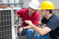 HVAC Technicians working on an A/C unit