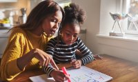 Mother and daughter studying together at table