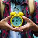 Student holding alarm clock