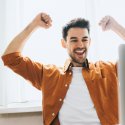 Man with arms upraised in sign of success