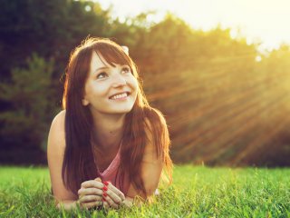 Woman in a field looking to the sky