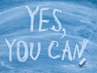 Motivational message "Yes you can!" written on a chalkboard