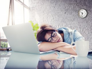 Young female asleep at desk