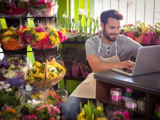 Professional Florist surrounded by blooms